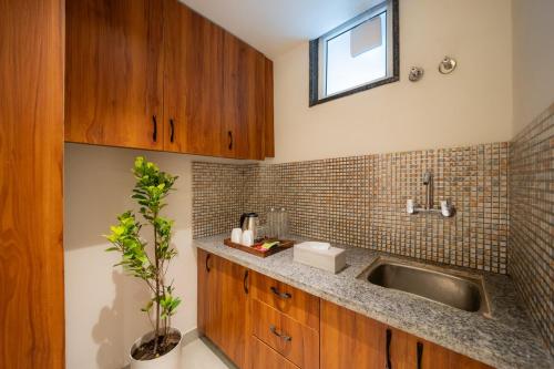 a kitchen with a sink and a window at Earth by The StayCationer in Dehradun
