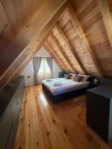 a bedroom with a bed in the attic at Stella Alpina in Žabljak