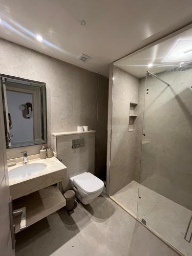 a bathroom with a toilet and a sink and a shower at Studio marina smir in Marina Smir