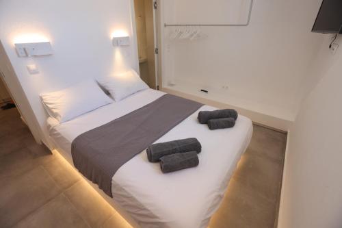 a bedroom with a bed with two towels on it at Liotrivi Luxury Residences in Kithnos