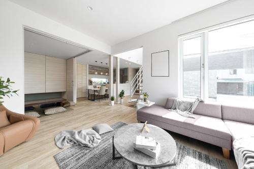 a living room with a couch and a table at The Prestige in Asahikawa
