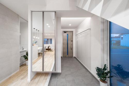 a hallway of a house with a glass door at The Prestige in Asahikawa