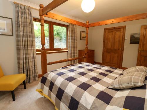 a bedroom with a bed and a window at Thistle Do in Lochailort