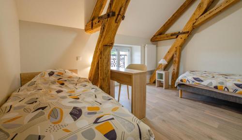a bedroom with a bed and a desk in a room at Numéro 3 in Morvilliers