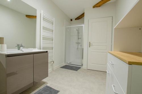 a white bathroom with a sink and a shower at Numéro 3 in Morvilliers