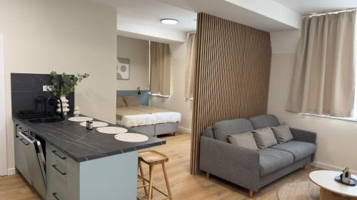 a kitchen and living room with a couch and a bed at AH Residence Anička in KoÅ¡ickÃ© KÃºpele