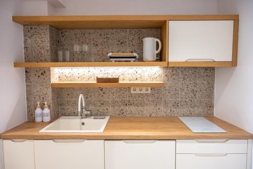 a kitchen with a sink and wooden counter top at Villa Maraki in Agia Paraskevi