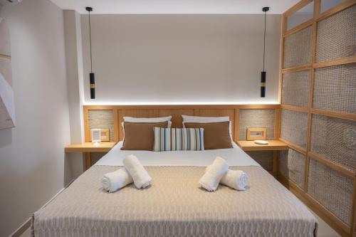 a bedroom with a bed with two pillows on it at Villa Maraki in Agia Paraskevi