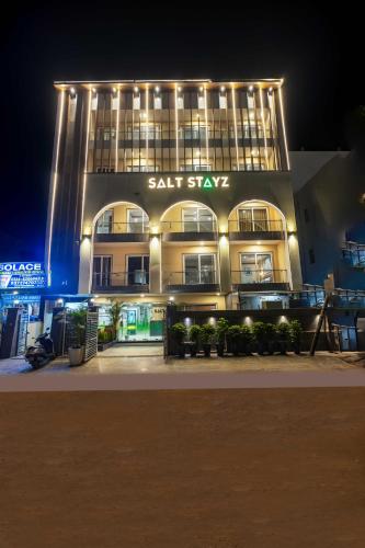 a large building with lights on it at night at Saltstayz Select- Medicity Near Medanta Hospital in Gurgaon