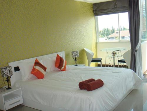 Кровать или кровати в номере Grand Residence Jomtien