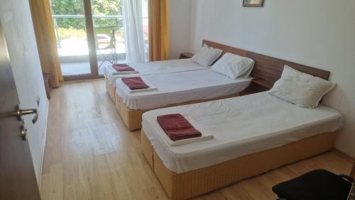 a room with two beds and a window at Apart Complex Pontica - Sea View 20 in Chernomorets