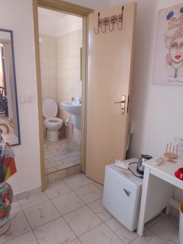 a bathroom with a toilet and a sink at Ippocampo in Giardini Naxos
