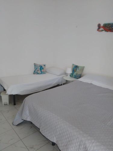two beds sitting next to each other in a room at Ippocampo in Giardini Naxos