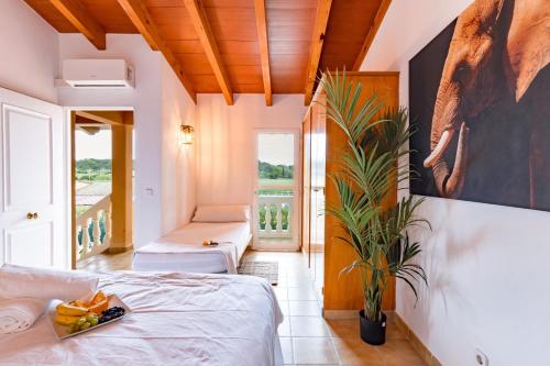 a bedroom with a bed and a painting on the wall at Villa Salvaje Beach in San Francesch