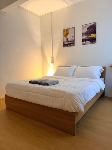 a bedroom with a large bed with white sheets at Kuantan Tiny Homestay in Kuantan