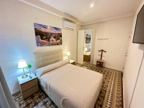 a bedroom with a bed and a cross on the wall at Rooms Balmes in Barcelona