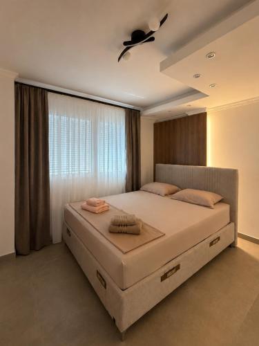 a bedroom with a large bed with a ceiling fan at BL Urban Stay in Starčevica