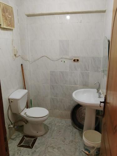 a bathroom with a toilet and a sink at Super star Chalet in Grand beach in Ras Sedr