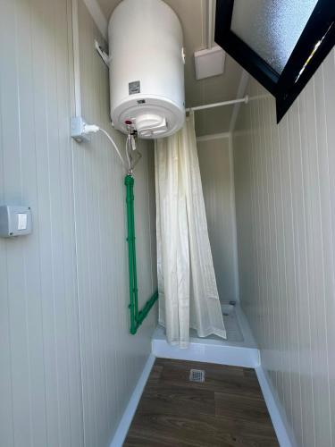 a bathroom with a light and a shower curtain at LakeSide Camping in Koplik