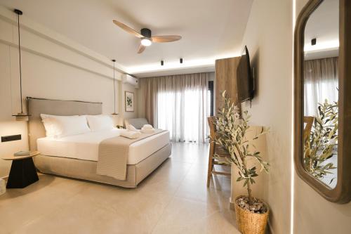 a bedroom with a bed and a ceiling fan at Sea Salt Skiathos in Skiathos