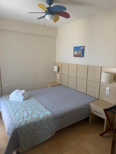 a bedroom with a bed and a ceiling fan at Amphipolis Deluxe Apartments in Ofrínion