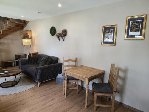 a living room with a couch and a table at Ferienhaus Frida in Kleinich