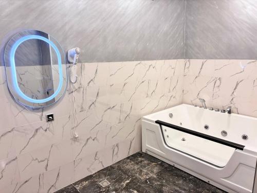 a bathroom with a sink and a mirror on the wall at Regal Hotel in Kapan
