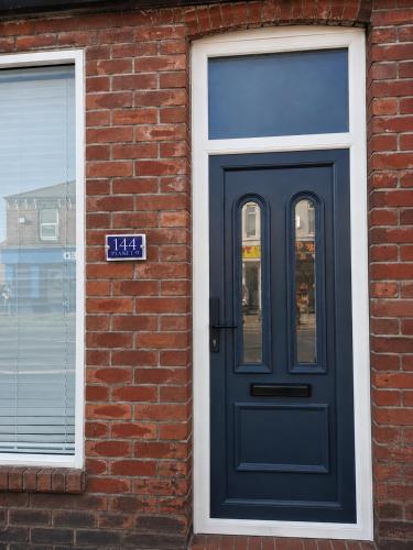 a blue door on the side of a brick building at Planet 9 in Warrington