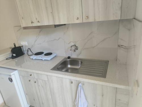 a kitchen counter top with a sink and a sink at Alexandros and Georgia in Ipsos