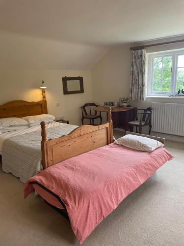 a bedroom with two beds and a table at Thorn Tree Garth in Coulton
