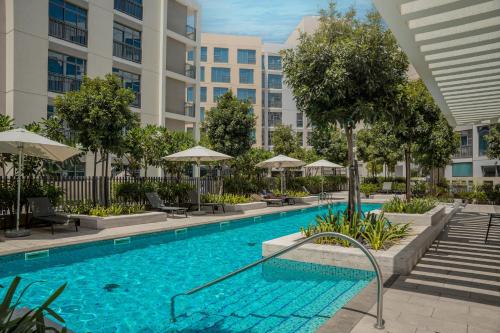 an image of a swimming pool at a building at Aesthetic Kings Studio at Uptown Al Zahia Sharjah in Sharjah