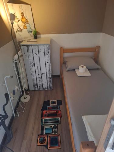 a small room with a bed with a shelf with books at Hostel Bed&Coffee 360° in Belgrade