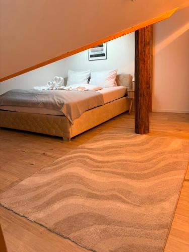 a bedroom with a bed and a rug at Eibisch Apartments in Passau
