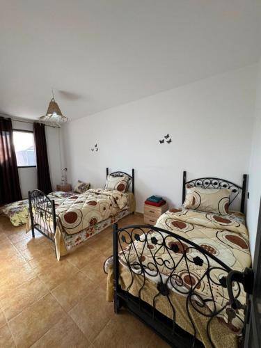 a bedroom with two beds in a room at Sidi kaouki Private House in Sidi Kaouki