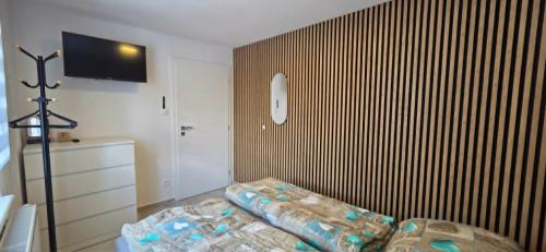 a living room with a couch and a flat screen tv at Apartmán U našich in Jeseník