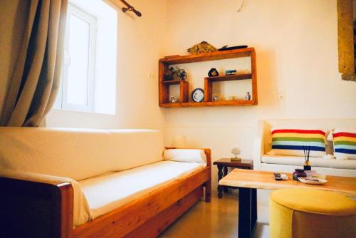 a living room with a couch and a table at Case De Drymona 1 in Kythira