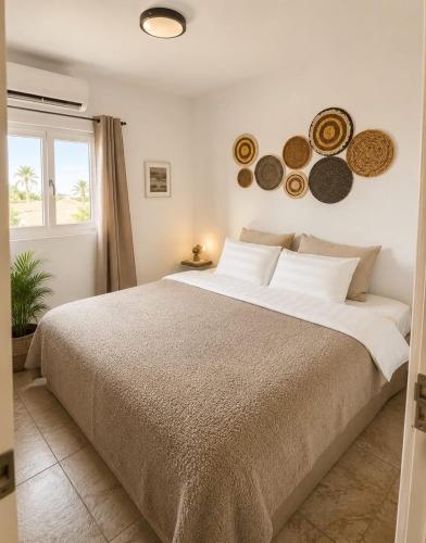 a bedroom with a large bed and a window at Island Vibes Apartment in Noord
