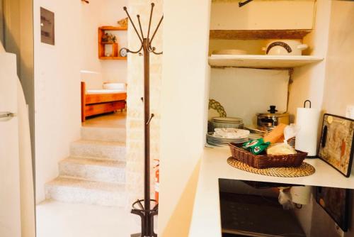 a staircase in a living room with a stair case at Case De Drymona 1 in Kythira