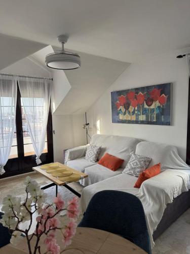 a living room with two couches and a table at Luz del Sur in Antequera