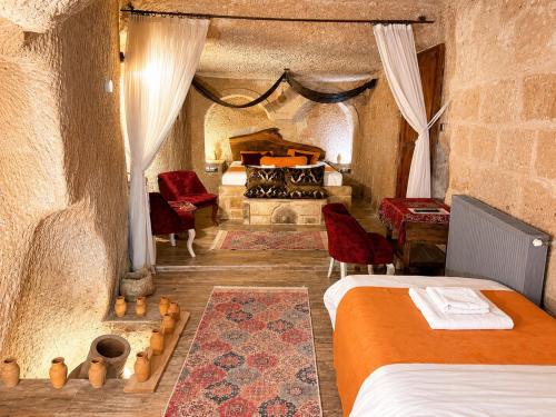 a bedroom with two beds and a bed in a cave at Cappadocia Cave House in Ürgüp