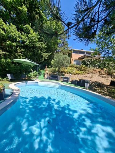 a swimming pool in a yard with trees at Gite des vallées d'Azur in Puget-Théniers