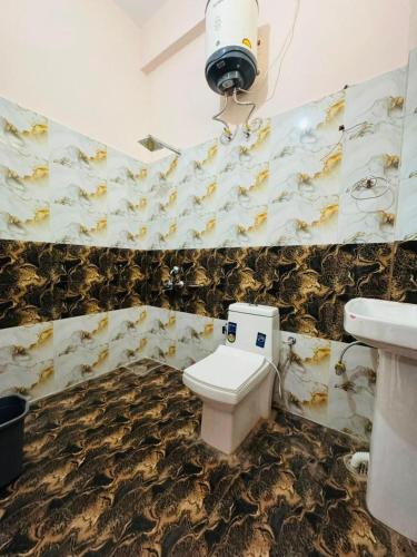 a bathroom with a toilet and a sink at Nirvana Homestay in Chamba