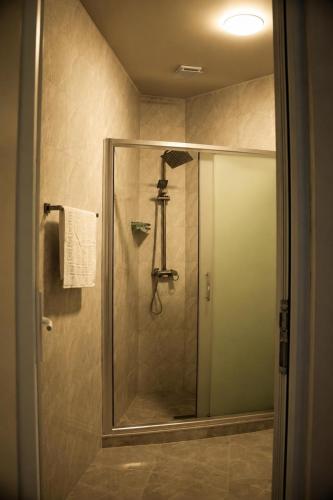 a shower with a glass door in a bathroom at VELOR Hotel apartment in Batumi