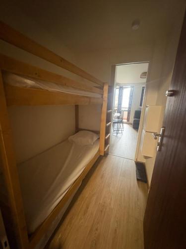 a small room with two bunk beds in it at Refuge 1000, studio cosy in Mijoux