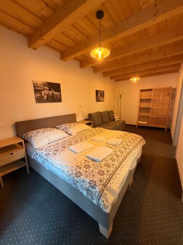 a bedroom with a bed and a couch at Chata ŠENKÁRKA Zuberec in Zuberec