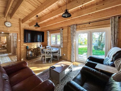 a living room with a couch and a table at The Cabin in Sevenoaks