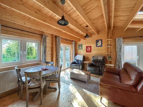 a living room with a table and a couch at The Cabin in Sevenoaks