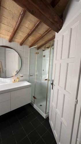 a bathroom with a shower and a sink and a door at Adagio Umbro in Sustrico Di Spoleto