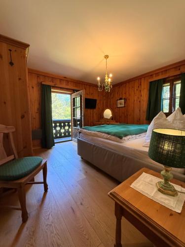 a bedroom with a large bed and a chandelier at Schlossmeierhaus - Kristall Lungau in Mauterndorf