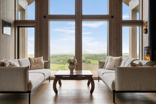 a living room with two couches and a table at Hoven Lodge in Vik